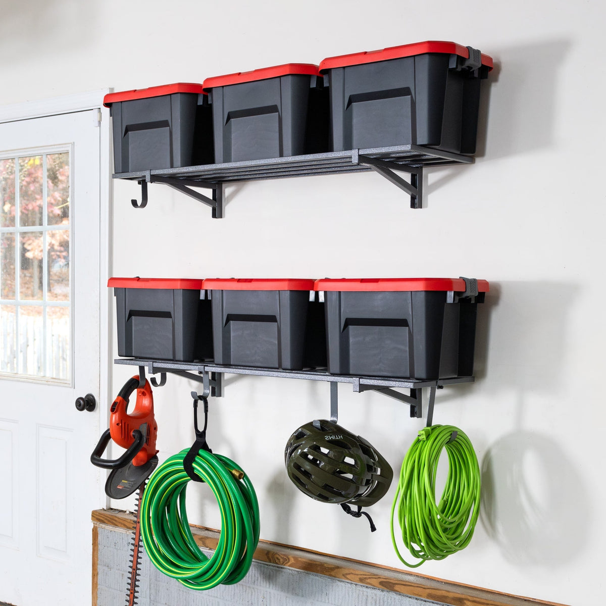 Two gray 1 x 4 ft wall shelves holding six totes with hoses hung from the hooks