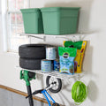 Two white 2 x 4 ft wall shelves holding bins, tires, garden supplies, a hose and a bike