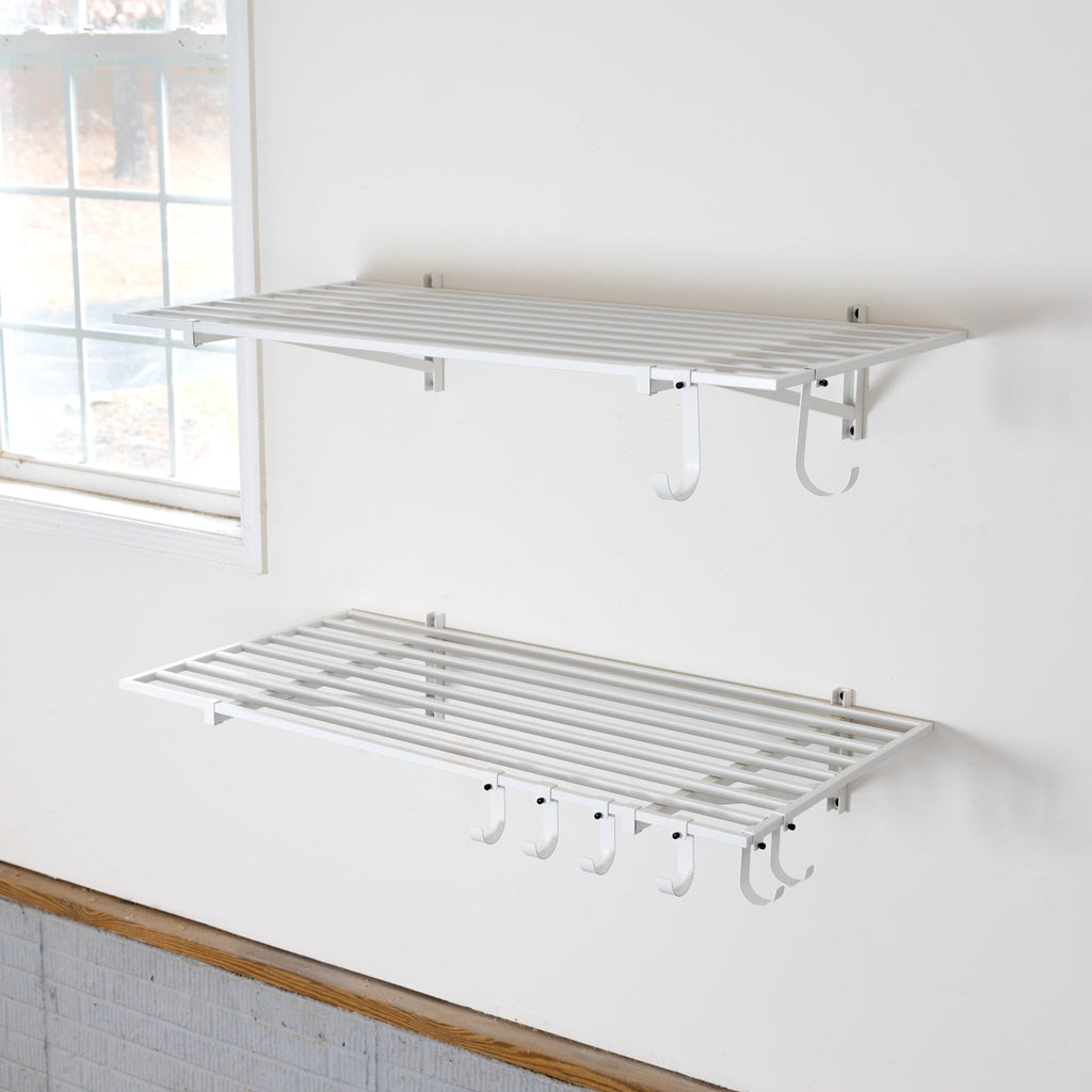 Two empty white 2 x 4 ft wall shelves with hooks underneath