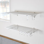 Two empty white 2 x 4 ft wall shelves with hooks underneath