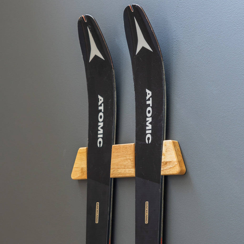 Pair of skis displayed on the Vail wood wall rack
