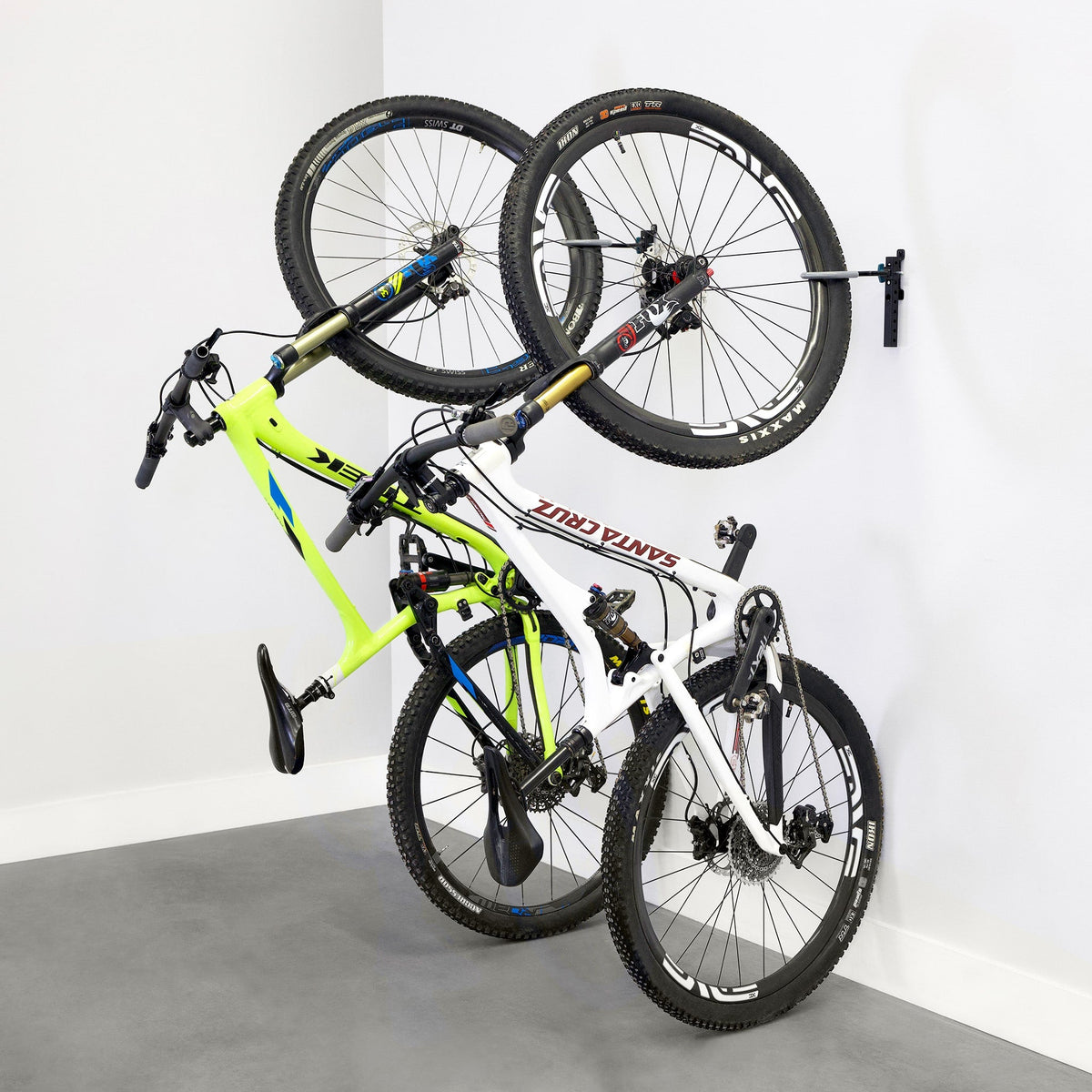 Two bikes hanging on WheelRest wall hooks