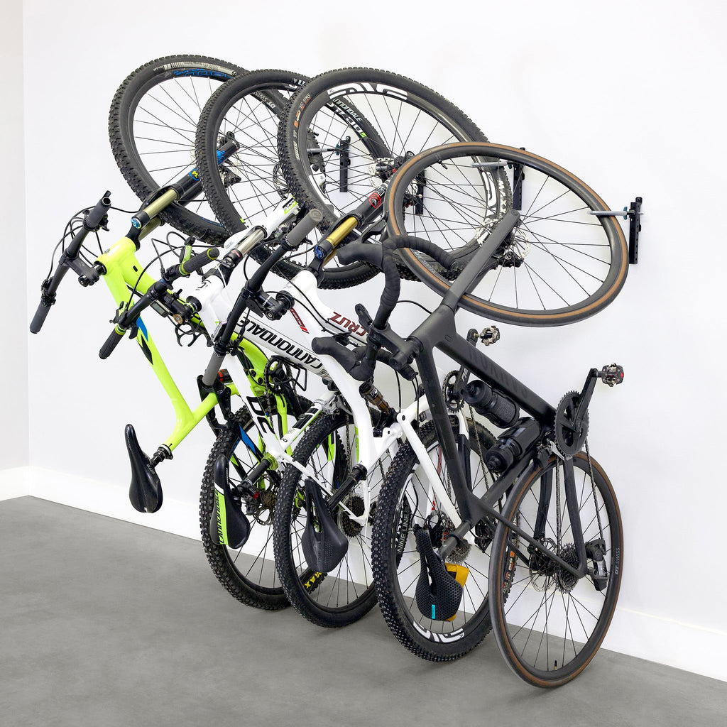 Four bikes hanging on WheelRest wall hooks, angled view