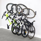 Four bikes hanging on WheelRest wall hooks, angled view