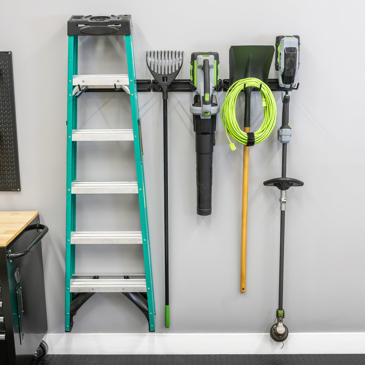 Ladder, leaf blower, hose and trimmer hung on the 48-inch wall organizer